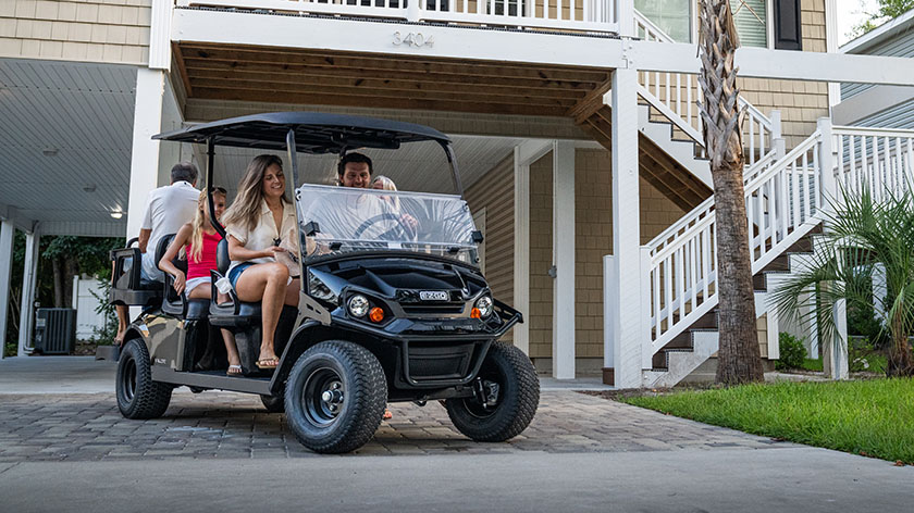 A family riding in their E-Z-GO golf cart.