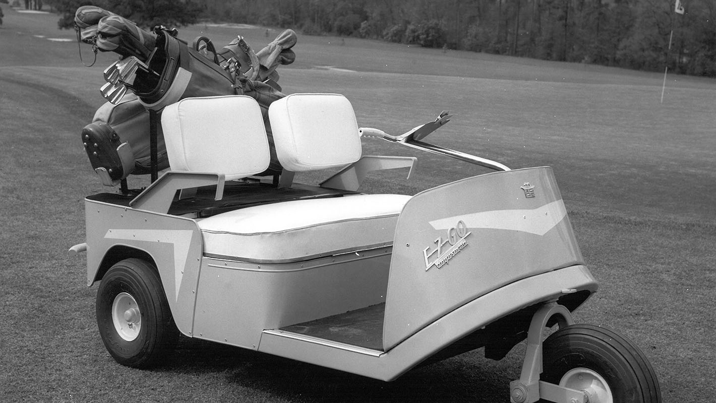 A black and white photo of a classic E-Z-GO golf cart (1954)
